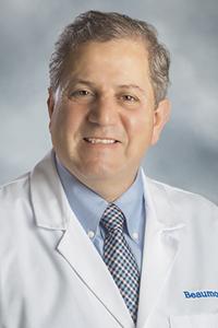 Dr. Kheir M. Al-Zouhayli in a white medical coat